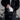 Urban cyclist holding a black folded FEND Super portable helmet outdoors, wearing a black jacket.