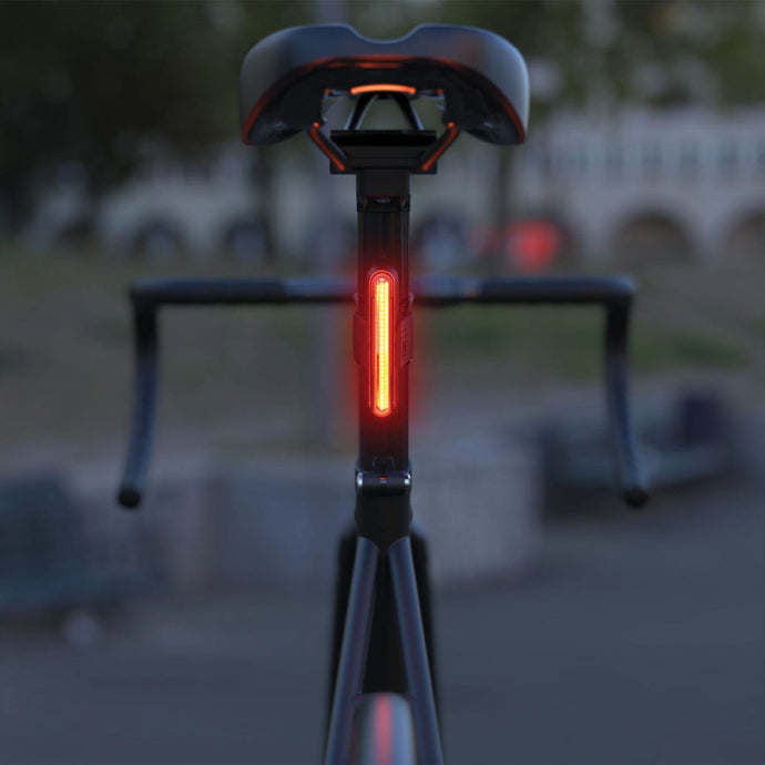 FEND Super long lasting bike tail light, glowing bright red mounted on a bike's seat post using included mounts.