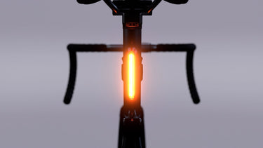 FEND Super Bike Tail Light mounted on a bike's seat post, glowing brightly for enhanced visibility.