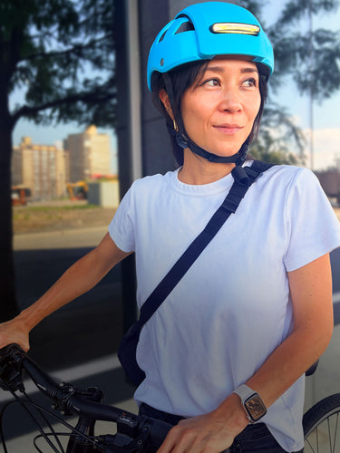 Sujene Kong, Co-Founder of FEND helmet, wearing FEND Super Plus helmet in color Hi-Vis Blue